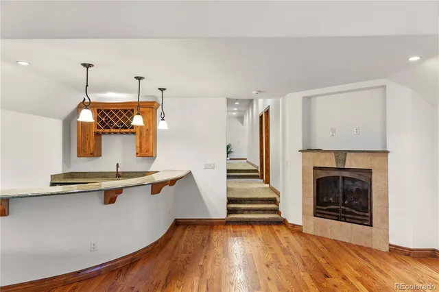 a view of a kitchen with a sink wooden floor and fire place