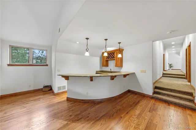 a view of kitchen with wooden floor and electronic appliances