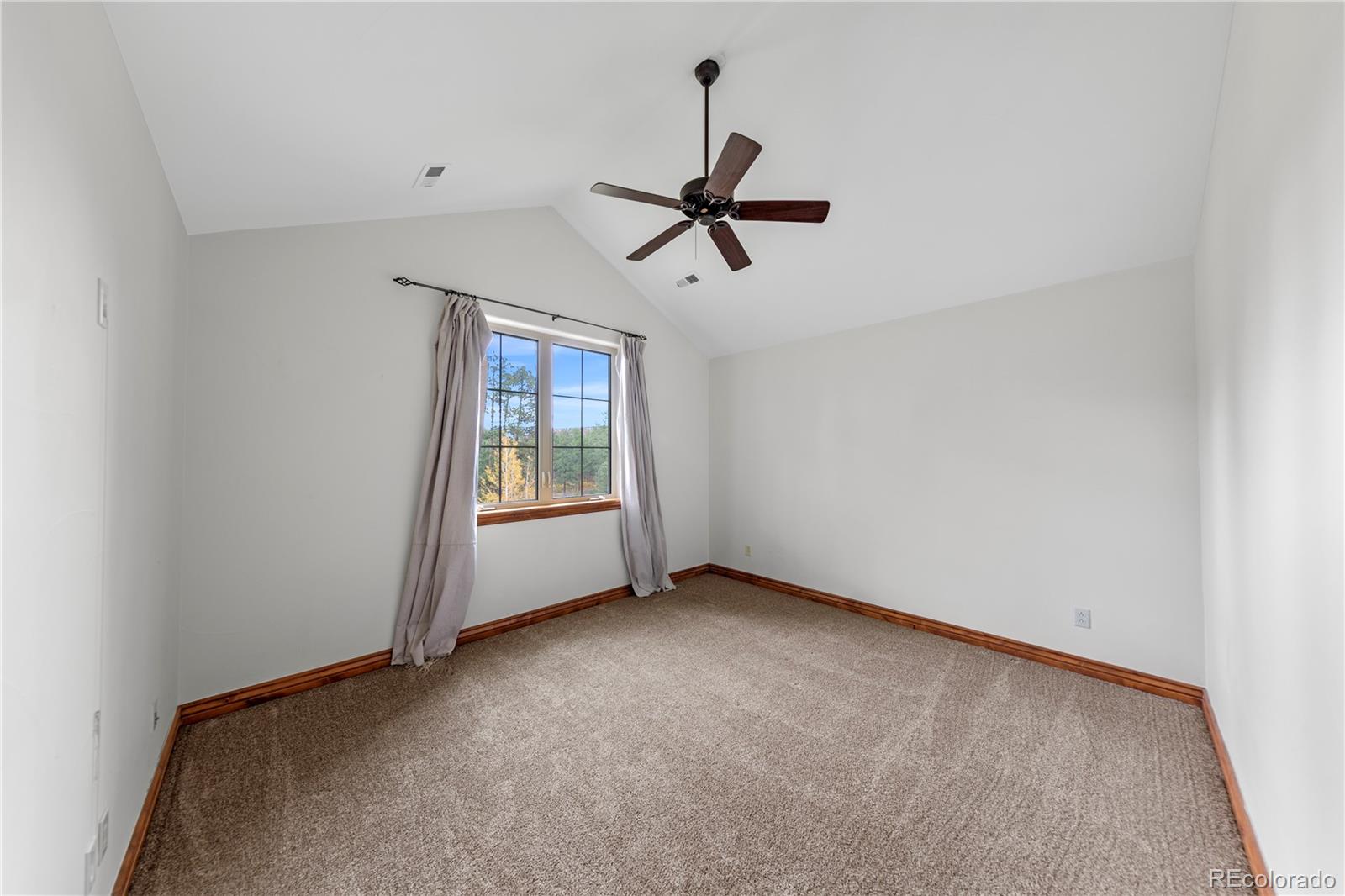 590 Cumberland Road Larkspur, CO 80118 - Photo 31 of 47 a view of room with a ceiling fan and window