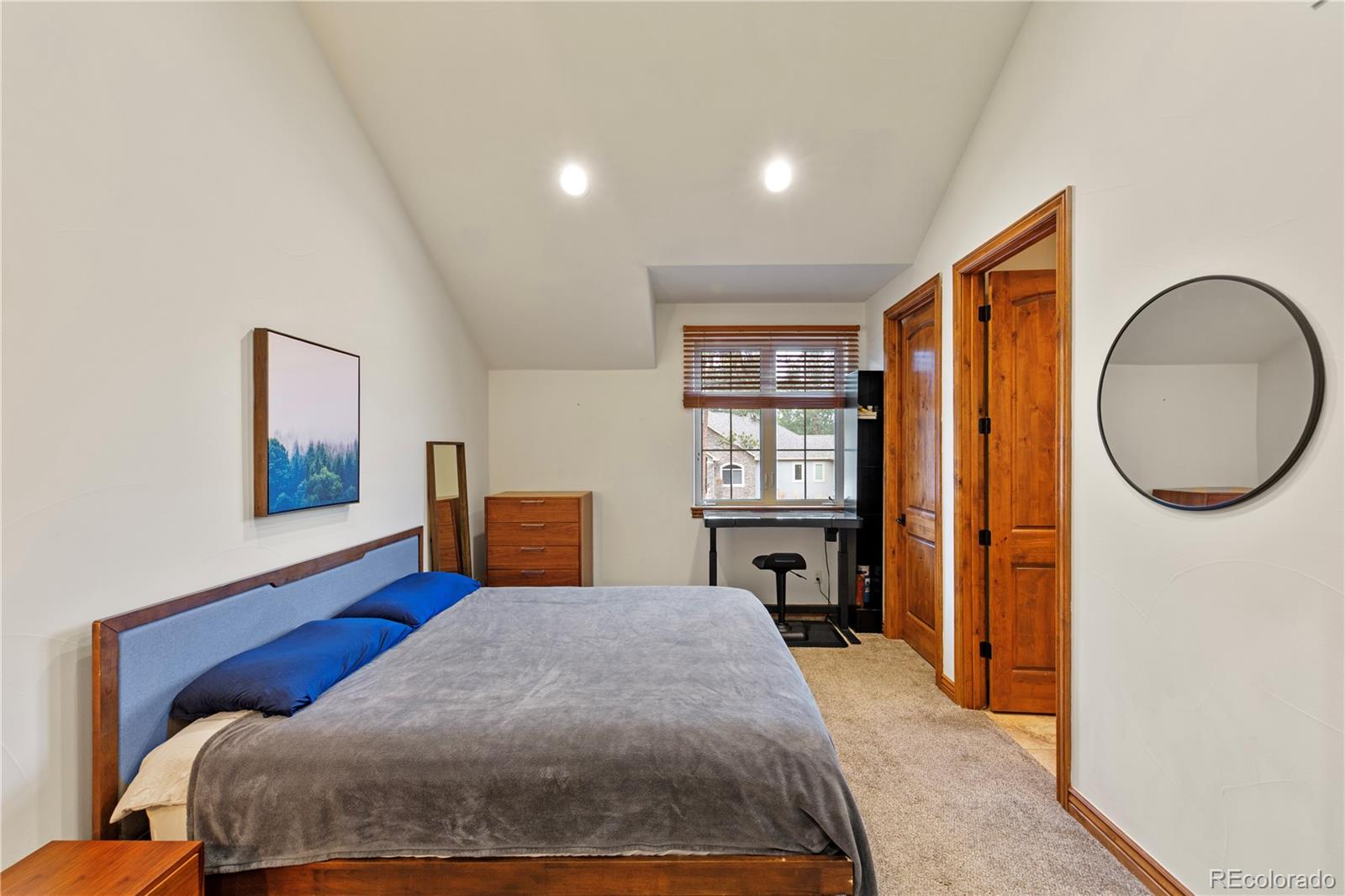 590 Cumberland Road Larkspur, CO 80118 - Photo 35 of 47 a bedroom with a large bed and a window