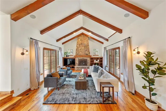 a living room with furniture fireplace and flat screen tv