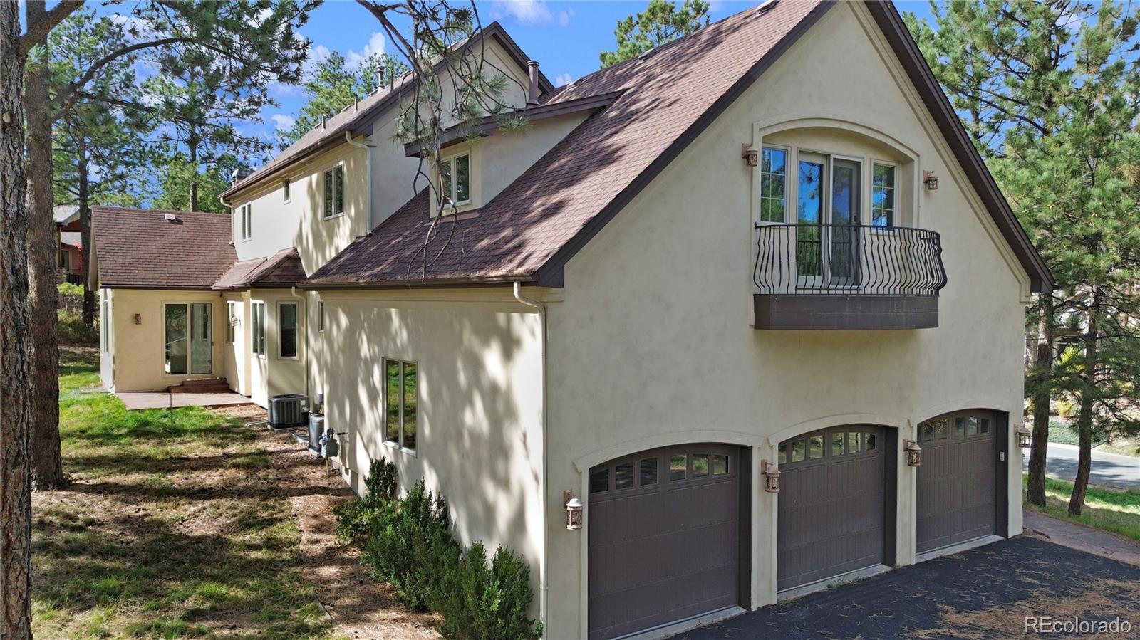 590 Cumberland Road Larkspur, CO 80118 - Photo 41 of 47 a front view of a house with a yard