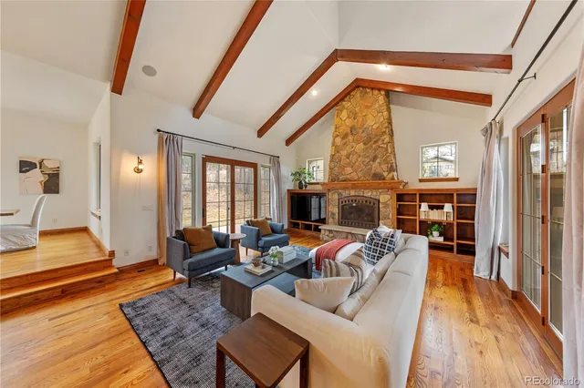 a living room with furniture fireplace and a table