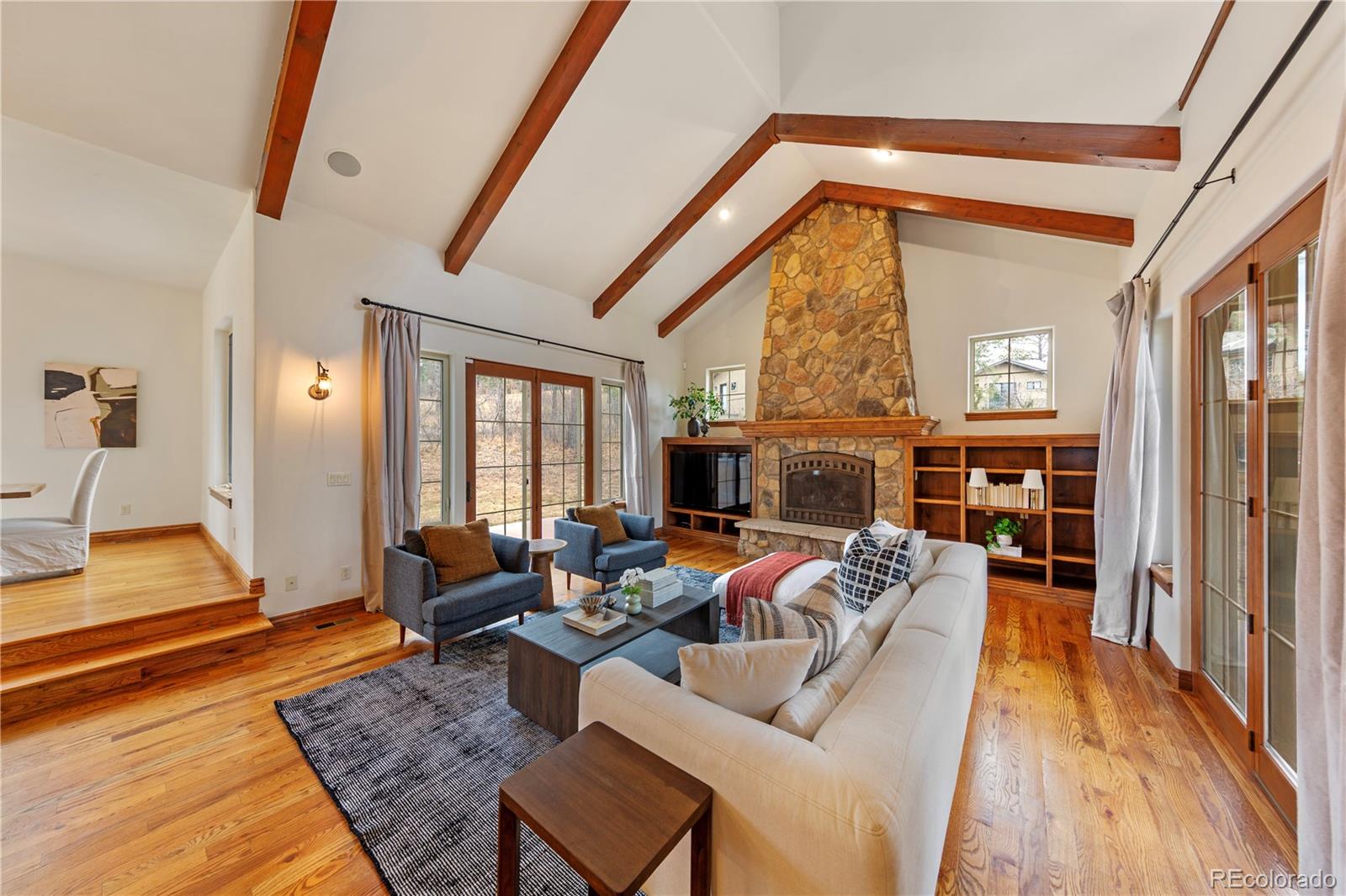 590 Cumberland Road Larkspur, CO 80118 - Photo 5 of 47 a living room with furniture fireplace and a table