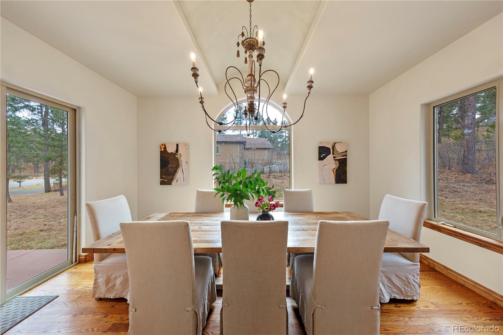 590 Cumberland Road Larkspur, CO 80118 - Photo 8 of 47 a view of a dining room with furniture a potted plant and wooden floor