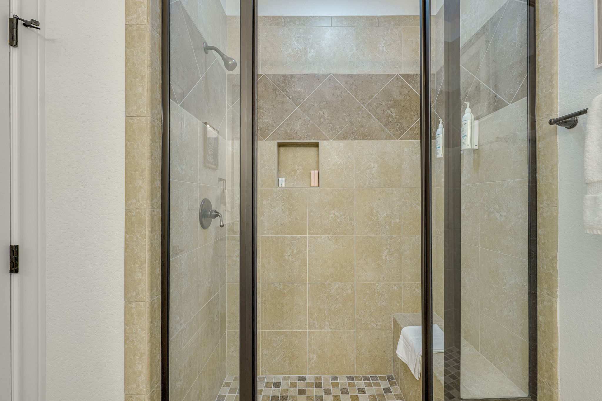 433 Venture Boulevard South Point Venture, TX 78645 - Photo 19 of 36 It also features an oversized shower with bench seating and tile surround.