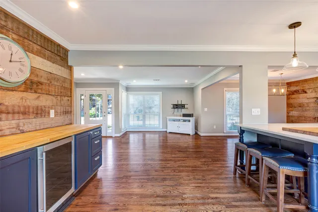 a large kitchen with stainless steel appliances granite countertop a stove and a wooden floors
