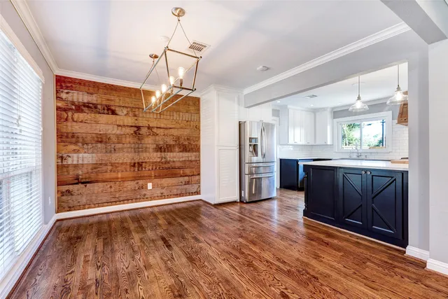 a open kitchen with a refrigerator a sink and a stove top oven