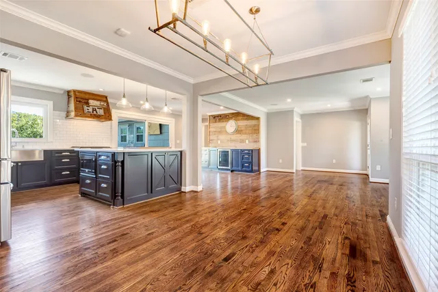 a living room with furniture and wooden floors