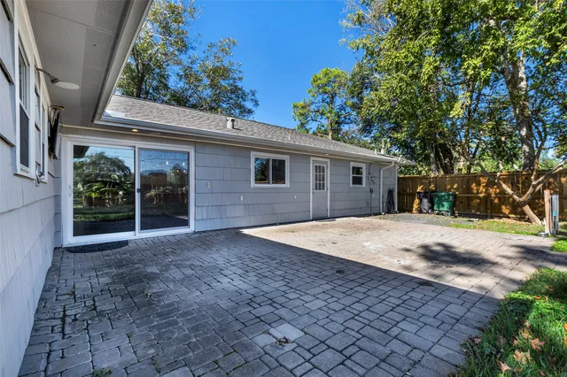 a front view of a house with a yard and potted plants