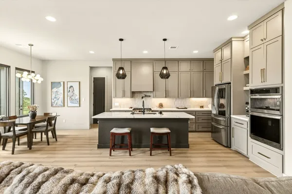 a large kitchen with kitchen island a sink and a stove