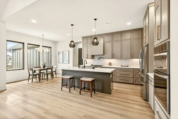 a large kitchen with lots of counter space and breakfast area