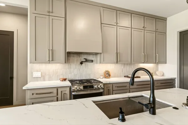 a kitchen with a sink cabinets and appliances