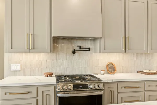 a kitchen with stainless steel appliances granite countertop a sink stove and cabinets