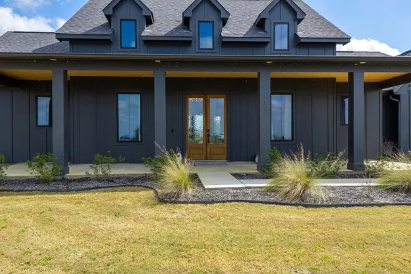 a front view of a house having swimming pool