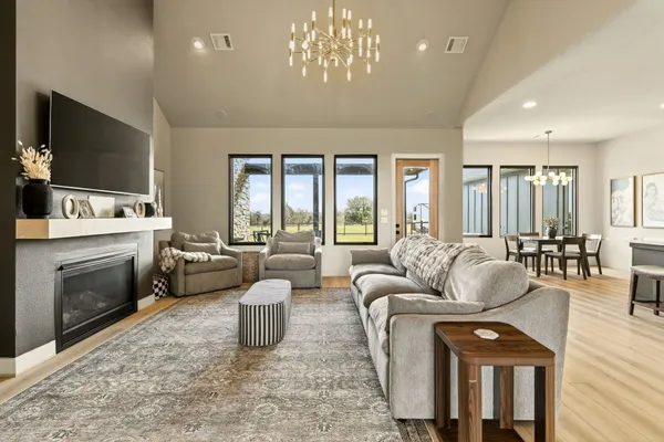 a living room with furniture a flat screen tv and a fireplace
