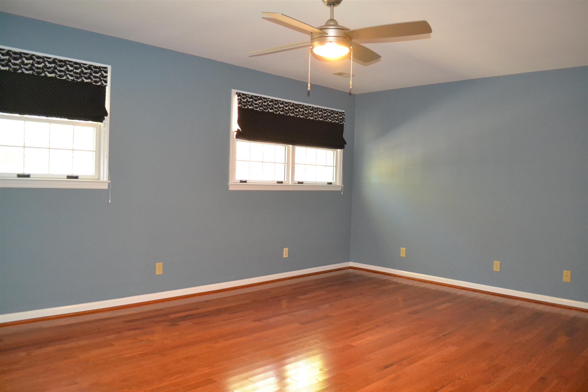 636 Cave Springs Road Lebanon, TN 37087 - Photo 13 of 18 an empty room with wooden floor fan and windows
