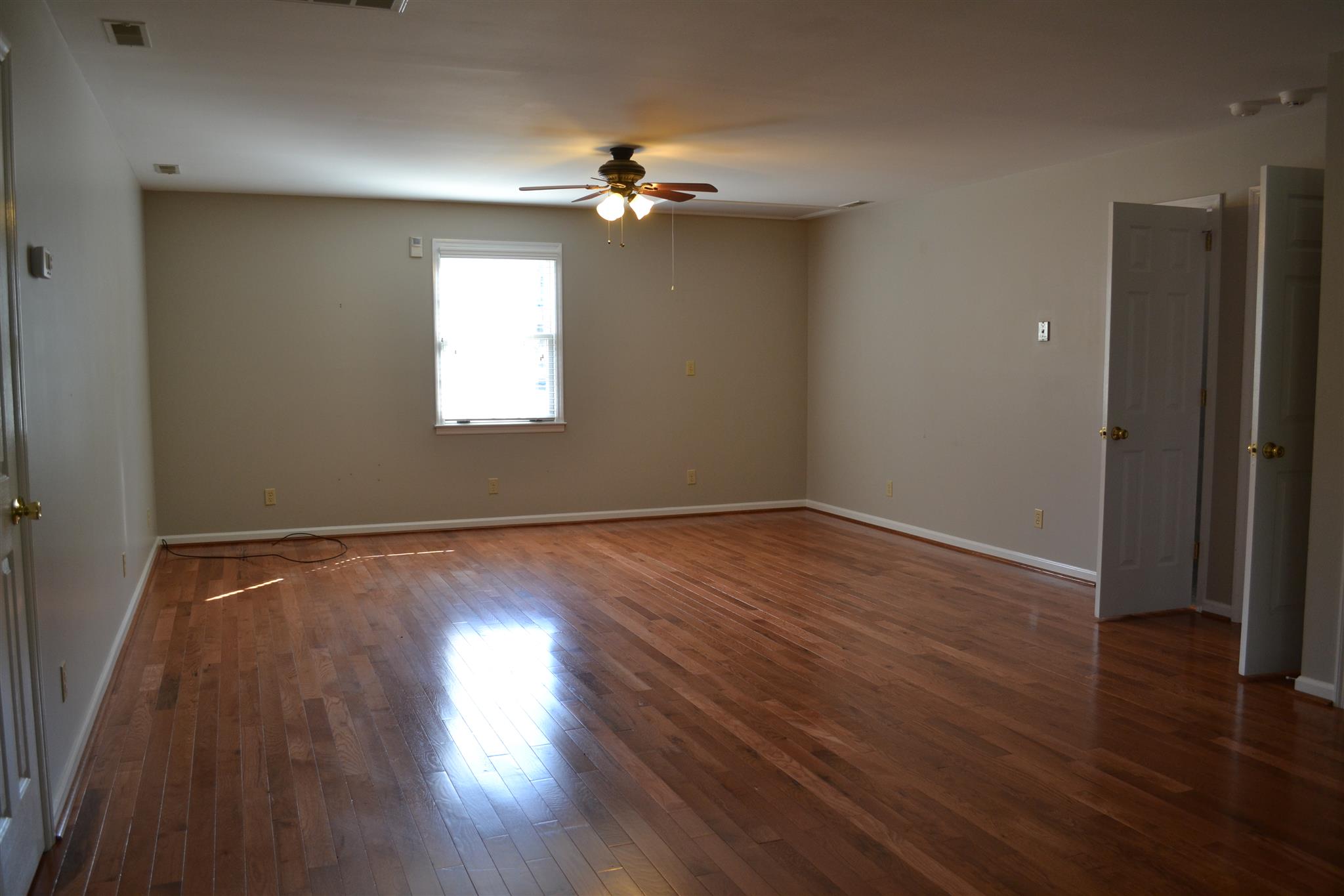 636 Cave Springs Road Lebanon, TN 37087 - Photo 16 of 18 a view of an empty room with wooden floor and a window