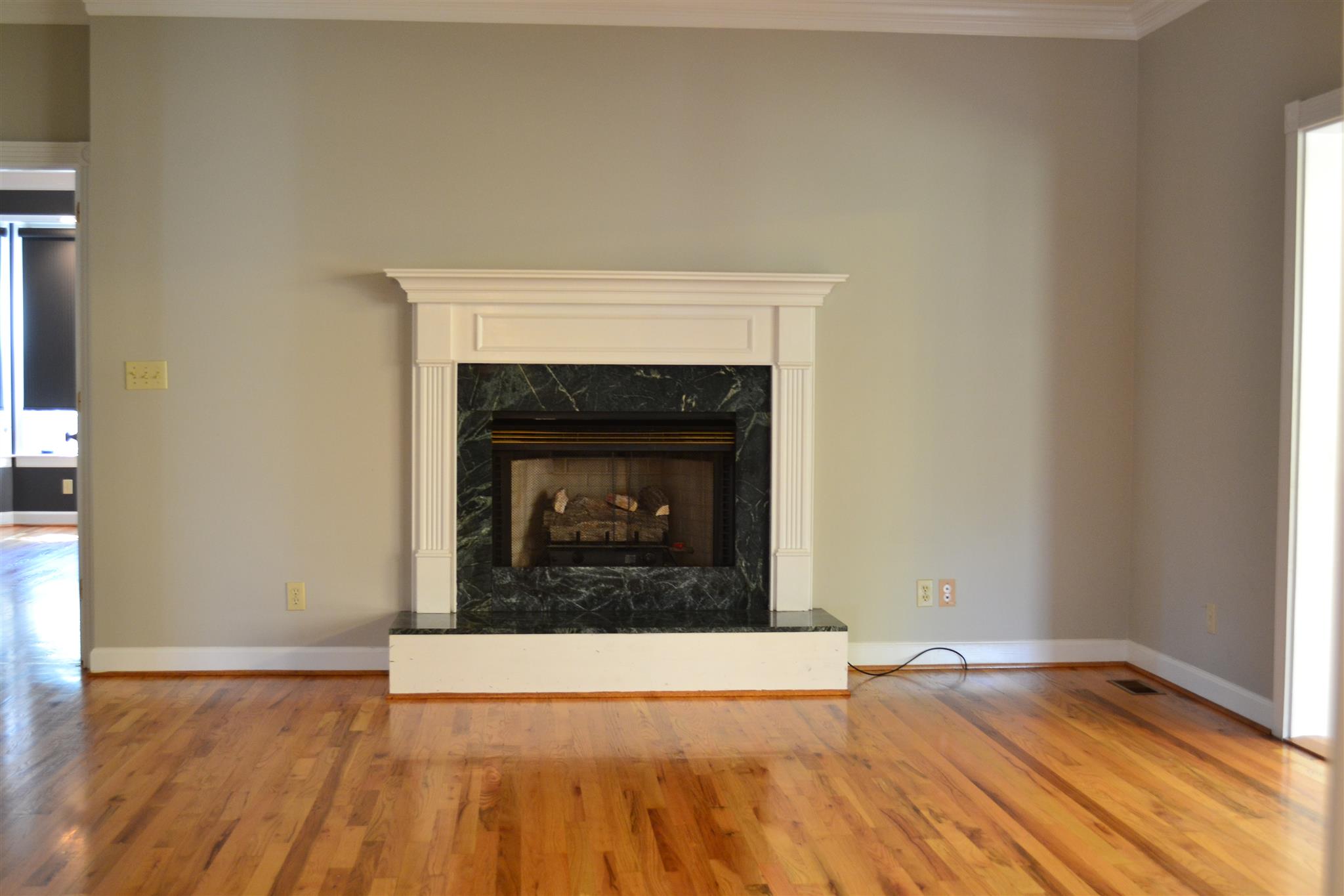 636 Cave Springs Road Lebanon, TN 37087 - Photo 4 of 18 a view of an empty room with wooden floor and a fireplace
