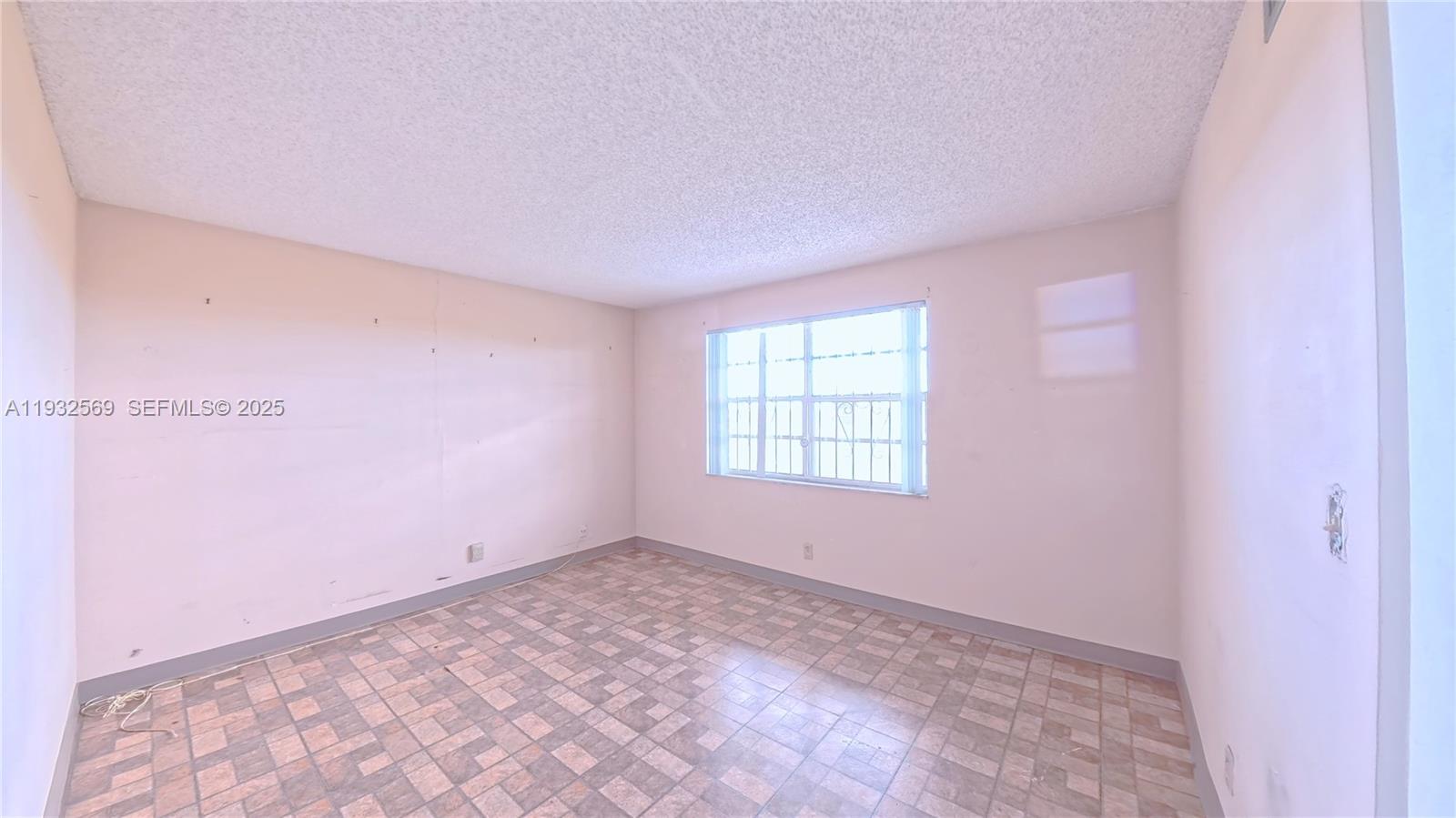 111 Southeast 3rd Avenue, Unit 502 Dania Beach, FL 33004 - Photo 13 of 14 a view of an empty room with a window