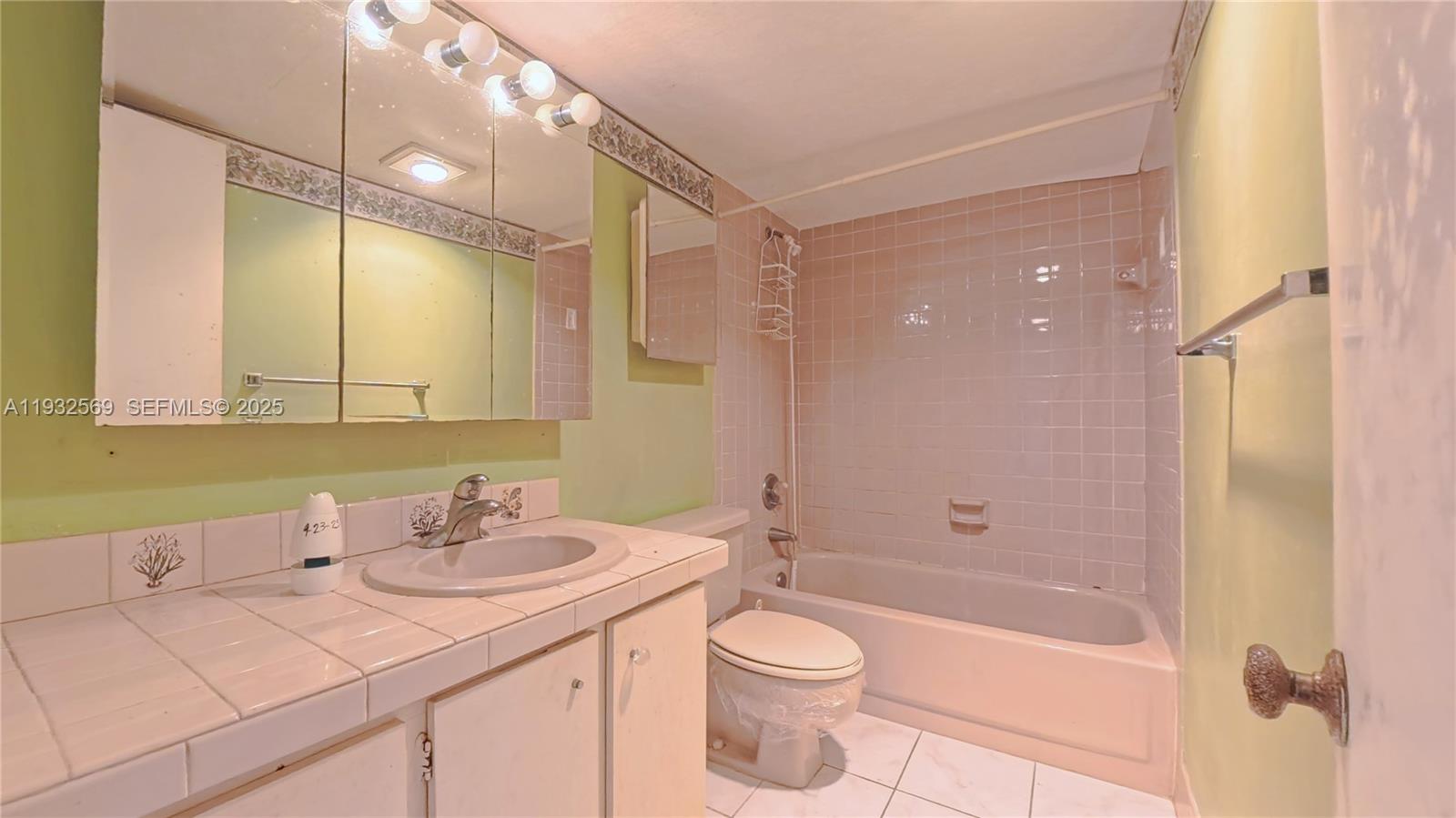 111 Southeast 3rd Avenue, Unit 502 Dania Beach, FL 33004 - Photo 14 of 14 a bathroom with a sink a toilet and shower