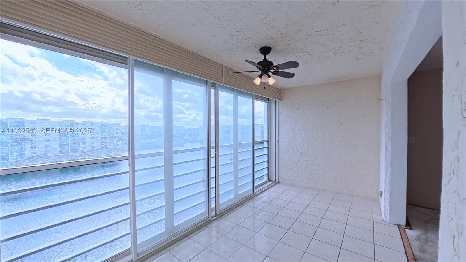 111 Southeast 3rd Avenue, Unit 502 Dania Beach, FL 33004 - Photo 4 of 14 a view of room with window and ceiling fan