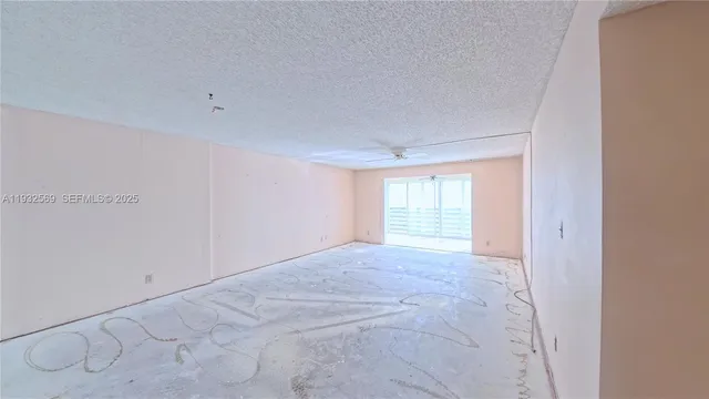 a view of a livingroom with a ceiling fan and window