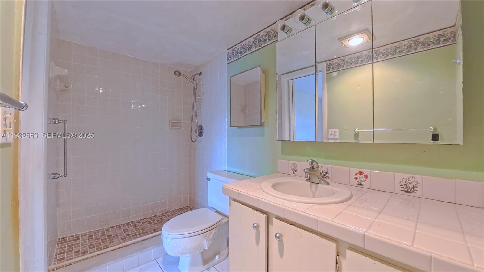 111 Southeast 3rd Avenue, Unit 502 Dania Beach, FL 33004 - Photo 10 of 14 a bathroom with a sink toilet and shower