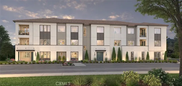 a front view of a residential apartment building with a yard