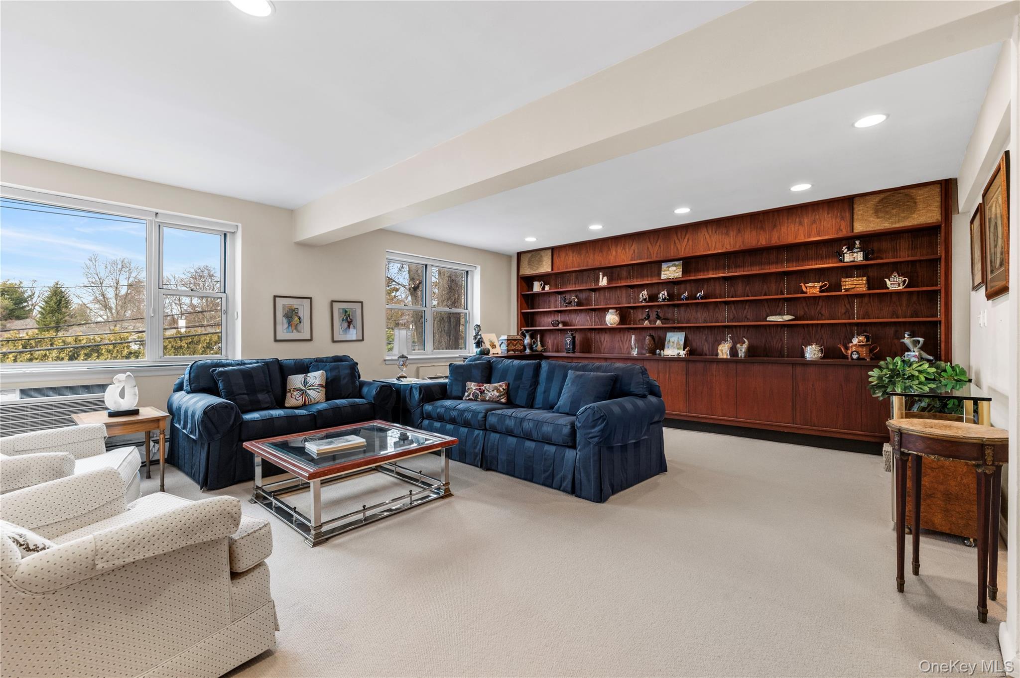 25 Chapel Place, Unit 2L Great Neck, NY 11021 - Photo 12 of 25 a living room with furniture and a large window