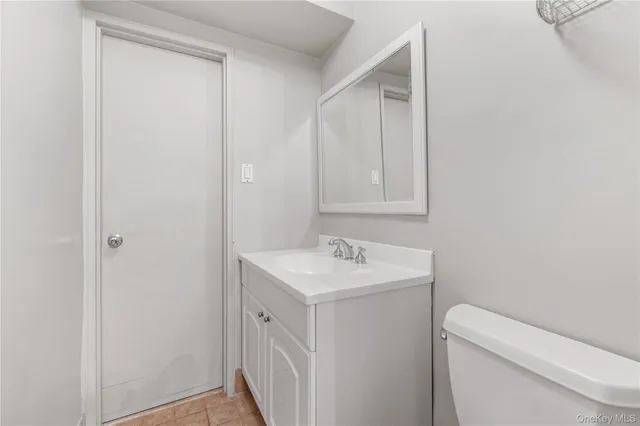 a spacious bedroom with a bed and a cabinets