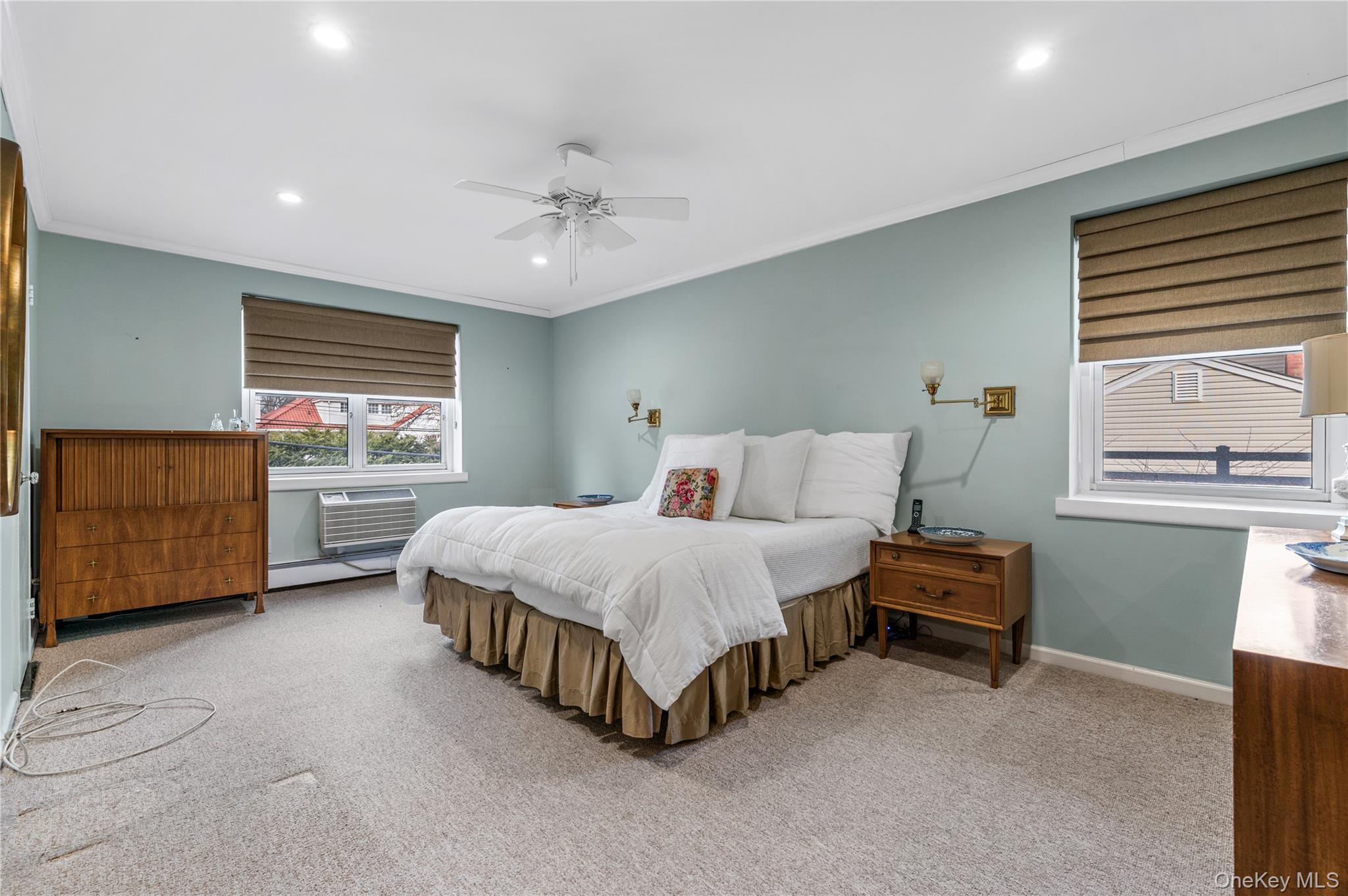 25 Chapel Place, Unit 2L Great Neck, NY 11021 - Photo 16 of 25 a spacious bedroom with a bed and a cabinets