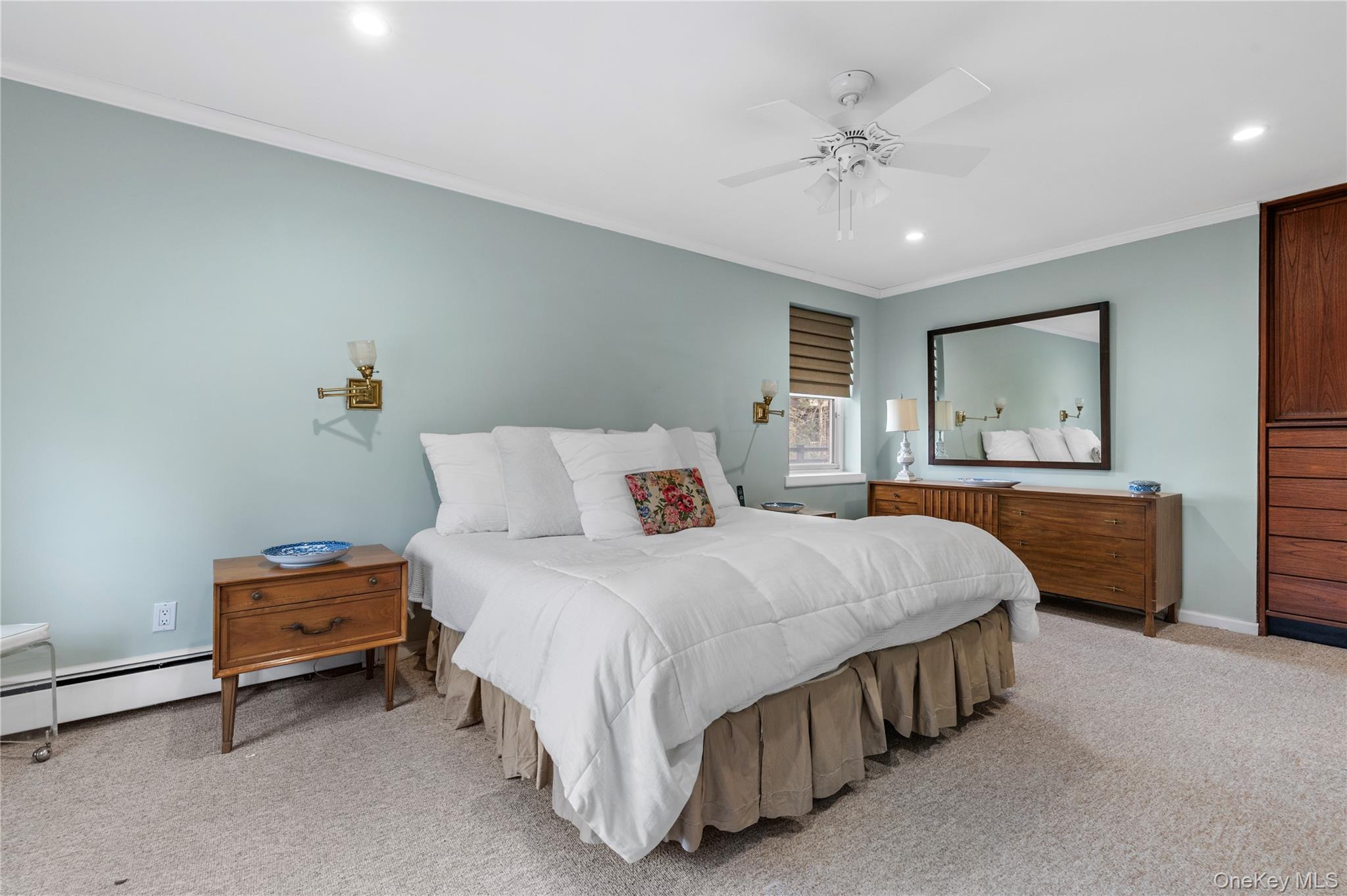 25 Chapel Place, Unit 2L Great Neck, NY 11021 - Photo 17 of 25 a bedroom with a bed and a chandelier