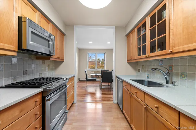 a kitchen with stainless steel appliances granite countertop a sink and a stove