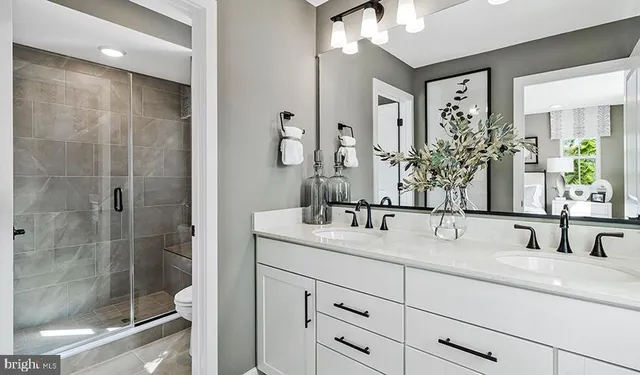 a bathroom with double sink and a mirror