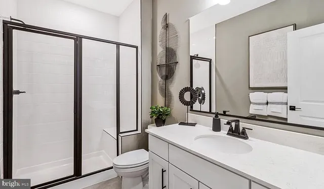a bathroom with a sink toilet and mirror