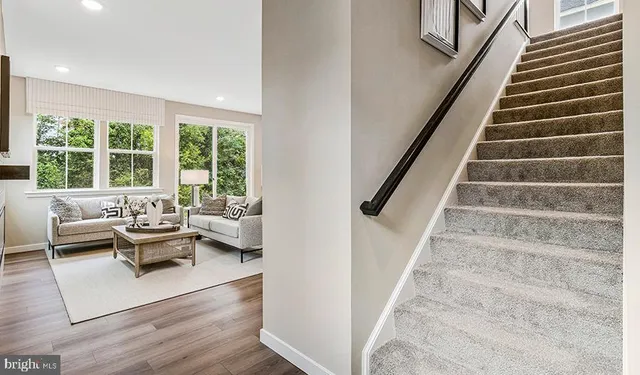a view of entryway and hall with wooden floor