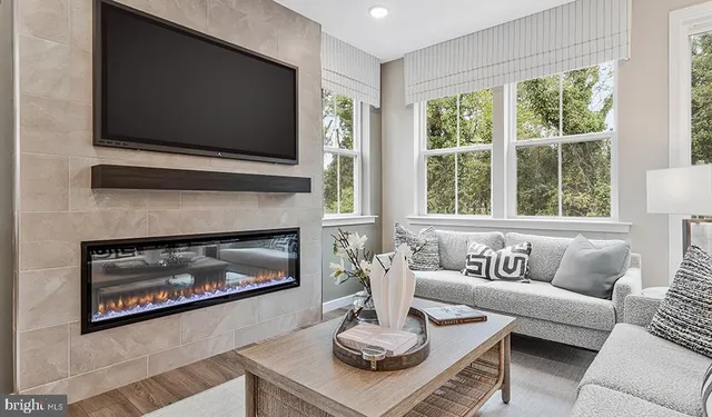 a living room with furniture a fireplace and a flat screen tv