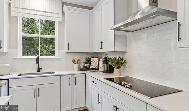 a kitchen with a sink cabinets and window