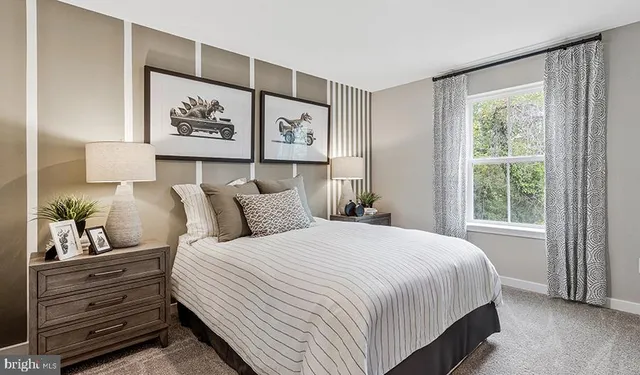 a bedroom with bed and painting on the wall