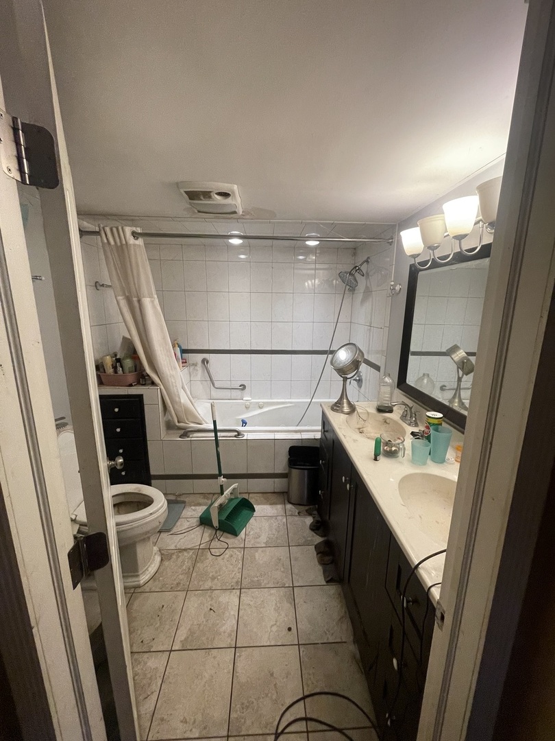 19227 Jacquie Avenue Romeoville, IL 60446 - Photo 12 of 17 a bathroom with a sink a toilet and a mirror