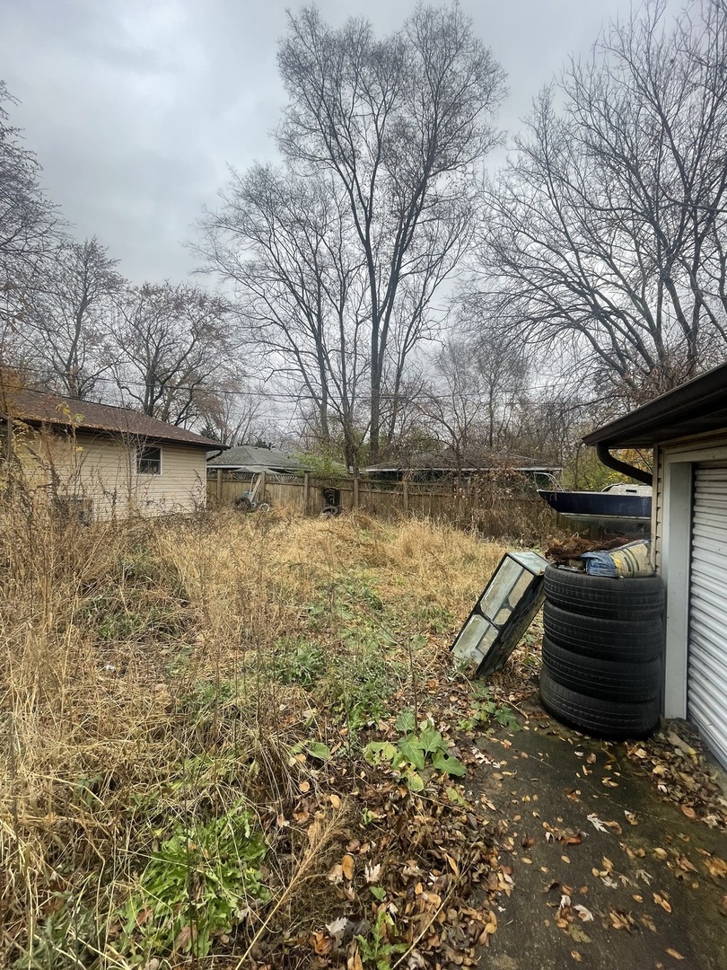 19227 Jacquie Avenue Romeoville, IL 60446 - Photo 15 of 17 a backyard of a house with barbeque oven and large trees
