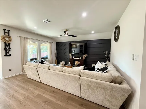 a living room with furniture kitchen view and a table