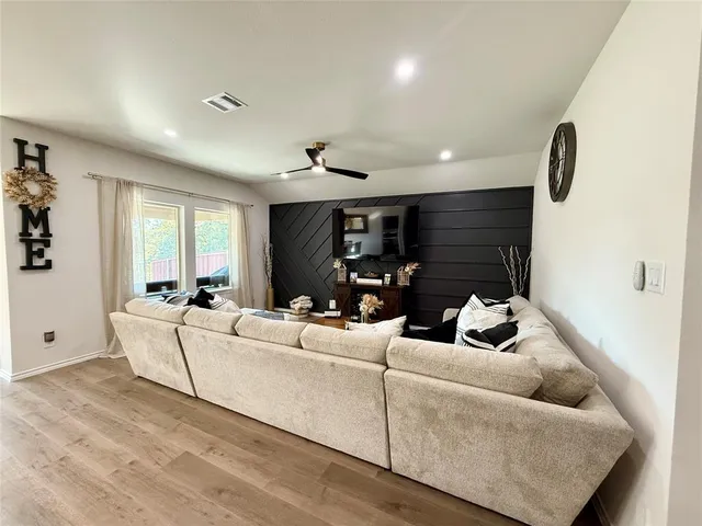 a living room with furniture kitchen view and a table
