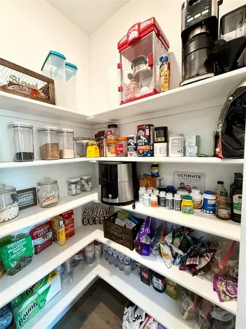 a large kitchen with a table and chairs in it