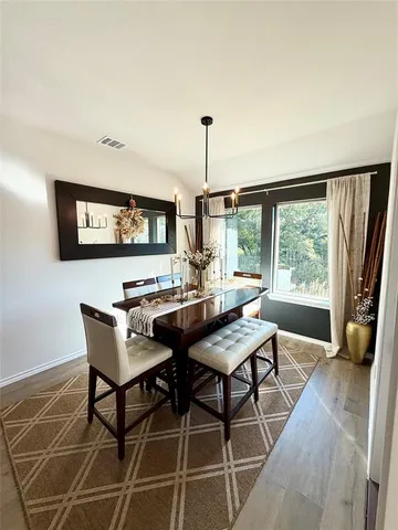 a view of a dining room with furniture window and outside view