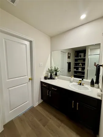 a spacious bathroom with a double vanity sink and mirror