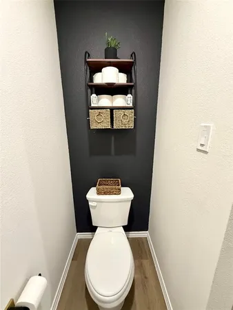 a white toilet sitting next to a white sink