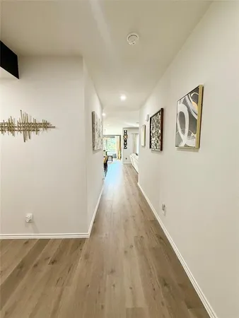 a view of a room with wooden floor