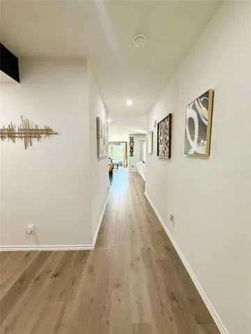 a view of a room with wooden floor